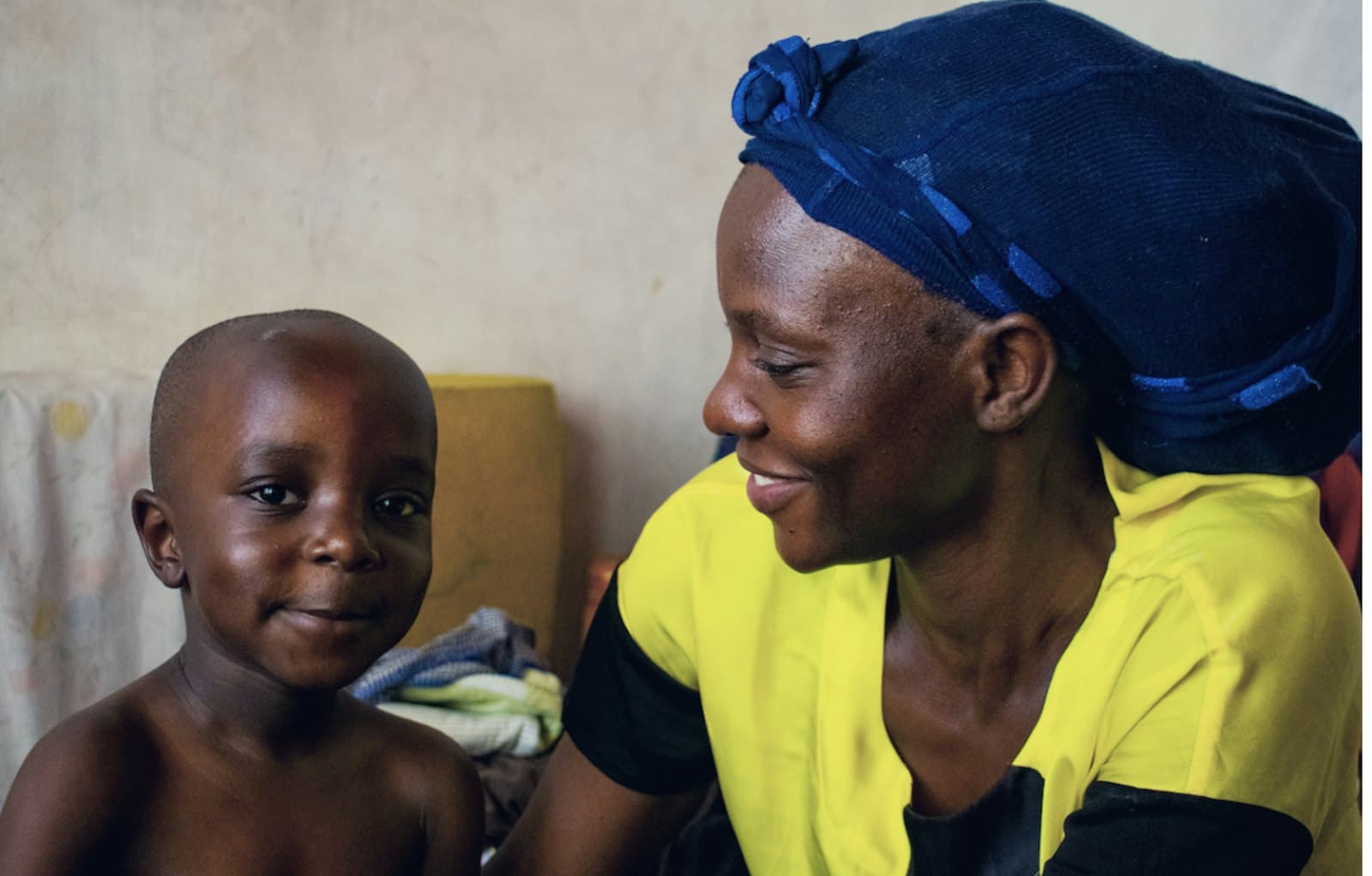 A caregiver smiling with a child