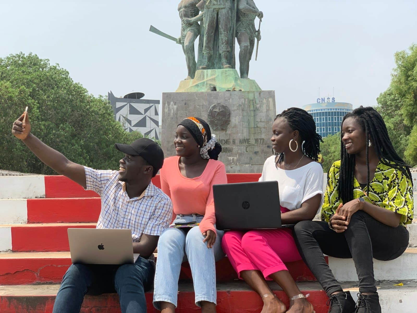 Young people collaborating with laptops